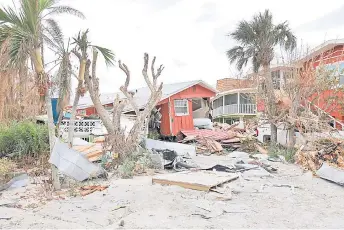  ?? — AFP photos ?? A destroyed building sits among debris after Hurricane Ian passed through the area in Sanibel, Florida.