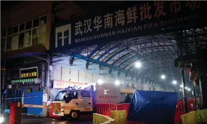  ??  ?? Wuhan hygiene emergency response team leave the closed Huanan market in January. The market waslinked to several of China’s first coronaviru­s patients. Photograph: Noel Celis/AFP via Getty Images