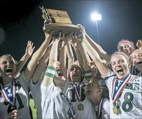  ?? Michael M. Santiago/Post-Gazette ?? Pine-Richland celebrates with the WPIAL Class 3A lacrosse trophy after beating Sewickley Academy, 11-3, in the title game Thursday night.