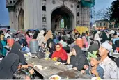  ?? P. Surendra ?? Faithful break their fast on the last day of Ramzan near Charminar in Hyderabad on Friday. (Above) The crescent sighted near the Macca Masjid Minaret on Saturday. —