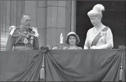  ?? (File Photo/AP) ?? Queen Elizabeth II — then Princess Elizabeth (center) — waves May 6, 1935, as she stands on the balcony of Buckingham Palace with her grandparen­ts King George V and Queen Mary. Princess Margaret is just visible over the balcony edge.