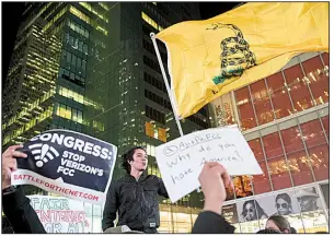  ?? AP/MARY ALTAFFER ?? Supporters of Net neutrality hold a rally in New York City as protests sprang up Thursday outside Verizon stores across the country.