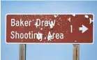  ??  ?? A bullet-damaged sign points the way to the Baker Draw shooting range, which is about 90 minutes north of Denver.