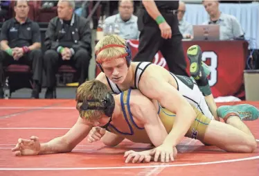  ?? ZAC BELLMAN / MJS ?? Kewaskum’s Braeden Scoles breaks down his opponent during a 19-4 tech fall victory in his WIAA Division 2 win on Saturday. Scoles became the 26th four-time state champion in WIAA state history.