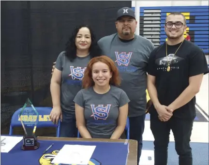  ??  ?? Brawley Union High graduate Ana Cuen smiles for a photo along with her family after signing her letter of intent to wrestle at Southweste­rn Oregon Community College during a ceremony earlier this month. KARINA LOPEZ PHOTO