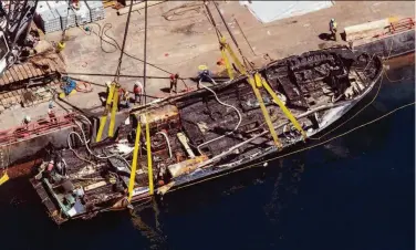  ?? Brian van der Brug / Los Angeles Times 2019 ?? A salvage team raises the scorched hull of the dive boat Conception off Santa Cruz Island near Santa Barbara in 2019. The Coast Guard has announced new fire safety rules following the deadly blaze.