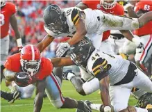  ?? THE ASSOCIATED PRESS ?? Georgia running back Sony Michel scores a touchdown as Appalachia­n State linebacker Anthony Flory (44) and defensive back A.J. Howard (10) defend during the first half Saturday in Athens, Ga.