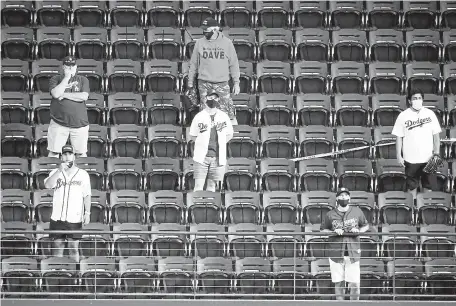  ?? Tony Gutierrez, The Associated Press ?? Fans watch batting practice before Game 2 of the NLCS on Tuesday in Arlington, Texas.