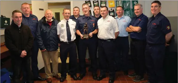  ?? Photo by Declan Malone ?? Denis Murphy (centre) who retired from the Dingle Fire Brigade on Thursday with colleagues, from left: Jim McCarthy, Normán Ó Conchúir, Walter Sheehy, Station Officer Breandán Ferriter, Artie Hand, Martin McSweeney, Assistant Chief Fire Officer for Kerry Michael Flynn, Mark Manning, Alan Flannery and Joe Lynch.