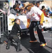  ?? Las Vegas Review-Journal file ?? Marquiste Kiles, 2, and Annette Walker Goggins dance at the 2018 Dr. Martin Luther King Jr. Parade.
