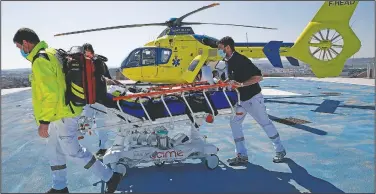  ??  ?? A helicopter drops off a patient on the rooftop of the Amiens Picardie hospital. France is facing a deadly surge of the virus that’s overwhelmi­ng many hospitals.