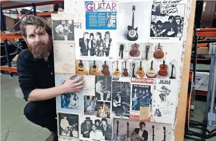  ?? Gardiner Houlgate/PA Wire ?? > Auctioneer Luke Hobbs with a wall panel belonging to the late guitar-maker Tony Zemaitis and, below, with a George Harrison drawing