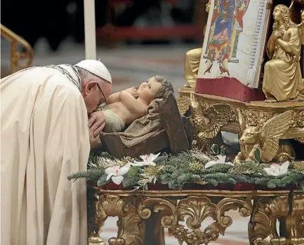  ?? PHOTO: AP ?? Pope Francis kisses a statue of the Divine Infant as he celebrates a new year’s eve vespers Mass in St. Peter’s Basilica at the Vatican.