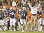  ?? DAVE MARTIN/ASSOCIATED PRESS FILE PHOTO ?? Auburn cornerback Chris Davis, center, returns a missed field goal-attempt 100-plus yards to score the winning touchdown as time expires in a 2012 game against No. 1 Alabama in Auburn, Ala.