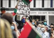  ?? JIM NOELKER / STAFF ?? Protesters march in downtown Dayton on May 30.