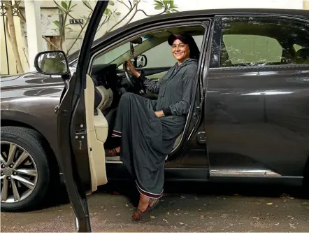  ??  ?? Saudi fashion designer Eman Joharjy models an abaya, the traditiona­l garment Saudi women wear, that she designed especially for driving. Saudi Arabia is scheduled to lift its ban on women driving, which has been in place since 1957, today.