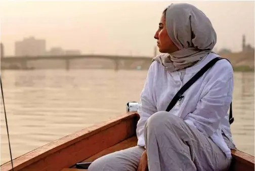  ?? File/agence France-presse ?? Iraqi activist Hajer Hadi is pictured on a boat sailing along the Tigris river in the capital Baghdad, on Sept. 23, 2021.