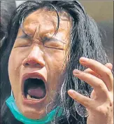  ?? AFP ?? A woman reacts after being hit with pepper spray during a face-off n
with police at an anti-beijing rally in Hong Kong on Wednesday.