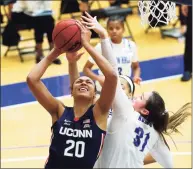  ?? Noah K. Murray / Associated Press ?? UConn’s Olivia Nelson-Ododa (20) goes to the basket against Seton Hall forward Alexia Allesch earlier this season.