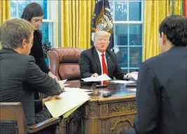  ?? Evan Vucci ?? The Associated Press President Donald Trump speaks Tuesday during an interview with The Associated Press in the Oval Office of the White House.