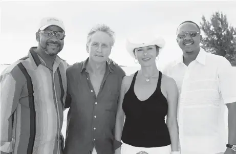  ?? FRAZER HARRISON / GETTY IMAGES ?? Premier of the Turks and Caicos Islands Michael Misick, left, actor Michael Douglas, actress Catherine Zeta-Jones and Premier of Bermuda
Ewart F. Brown pose for a photo on Callis Island while the Douglas family was on holiday in the Caribbean in 2007.