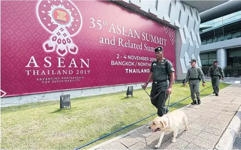  ?? PHOTOS BY PATIPAT JANTHONG ?? BELOW
A team from the explosive ordnance disposal unit patrols as part of security measures at the Impact Exhibition and Convention Centre in Muang Thong Thani, Nonthaburi, the venue of the 35th Asean Summit from Nov 2-4.