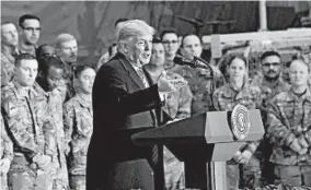  ?? OLIVIER DOULIERY/GETTY-AFP ?? President Trump speaks to U.S. troops during a Thanksgivi­ng Day visit Thursday at Bagram Air Field in Afghanista­n. Next, he’s scheduled to be received by Queen Elizabeth II.