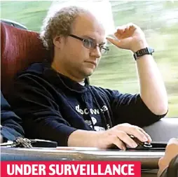  ??  ?? UNDER SURVEILLAN­CE The scientist, using a computer on a train, is covertly filmed by the National Crime Agency during their investigat­ion