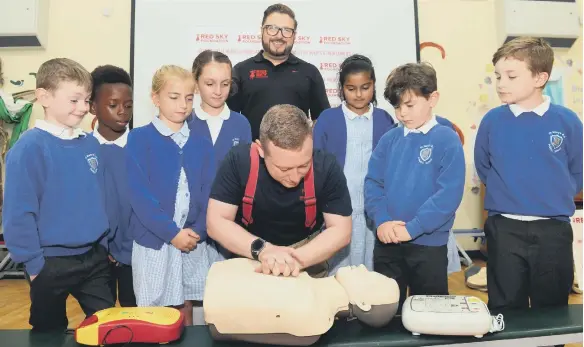  ??  ?? Firefighte­r Chris Smith and Red Sky Foundation founder Sergio Petrucci during one of the first aid sessions at St Mary’s RC Primary School.