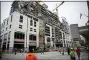  ?? SCOTT THRELKELD/THE ADVOCATE VIA AP ?? Constructi­on workers look on after a large portion of a hotel under constructi­on suddenly collapsed in New Orleans on Saturday.