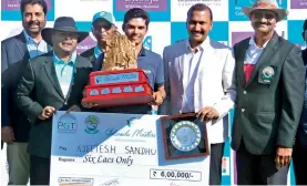  ??  ?? Ajeetesh Sandhu (centre) is all smiles as he holds the Golconda Masters trophy at the Hyderabad Golf Club on Sunday. Also seen in the photo are PGTI Director Uttam Singh Mundy (from left), Hyderabad Golf Associatio­n secretary K. Srikanth Rao, HGA...