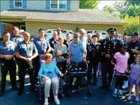  ?? DAN SOKIL — DIGITAL FIRST MEDIA ?? World War II veteran Harry Snyder of Upper Gwynedd, center, is saluted by friends, family and local police during a flag presentati­on ceremony on Thursday.