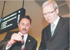  ?? ?? 2007: Then-labor leader Kevin Rudd campaignin­g for light rail with then-mcpherson candidate Eddy Sarroff.