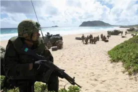  ??  ?? A soldier with the Japan maritime self-defense force is seen during a simulated beach assault at Marine Corps Base Hawaii during Rimpac in 2016. Photograph: Hugh Gentry/ Reuters