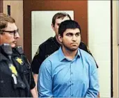  ?? BRANDY SHREVE/SKAGIT VALLEY (WASH.) HERALD ?? Arcan Cetin is escorted into Skagit County District Court in Mount Vernon, Wash., by sheriff ’s deputies Monday.