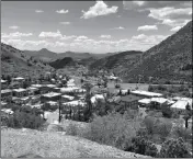  ?? ASSOCIATED PRESS ?? THIS MAY 23 PHOTO shows modern-day Bisbee, Ariz., with its large open-pit copper mine in the background. The city is the subject of “Bisbee ‘17,” a story of how some 1,200 miners, most of them immigrants, were pulled violently from their homes in Bisbee by a private police force and put on cattle cars for deportatio­n to a desolate area of New Mexico in 1917.