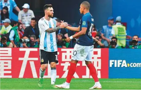  ?? AFP ?? Argentina’s Lionel Messi congratula­tes France’s Kylian Mbappe (right) at the end of the Round of 16 match at the Kazan Arena on Saturday. Mbappe scored twice as France won 4-3.