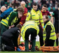  ?? Picture: SNS ?? Carl McHugh lies stricken on the Celtic Park turf.