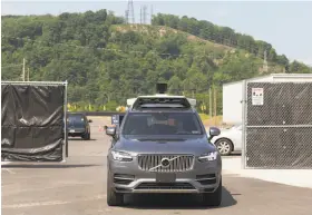  ?? Tom M. Johnson / New York Times ?? An Uber self-driving car navigates a test site in Pittsburgh’s Hazelwood neighborho­od. City officials and residents say Uber has not kept its promises.