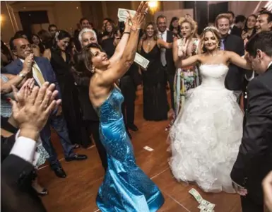  ?? APRIL GREER FOR THE WASHINGTON POST ?? The Greek money dance is a nod to groom Alex Spithas’s heritage at his wedding to Iranian bride Shabnam Nowrouzi.