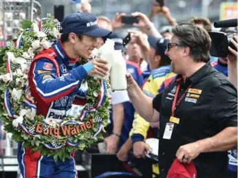  ?? CHRIS OWENS/INDYCAR ?? Takuma Sato, left, and Michael Andretti share a toast after the Japanese driver won the Indianapol­is 500 in May.