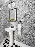  ??  ?? To add some personalit­y to the space, the Hoburgs put up removable wallpaper tiles.
