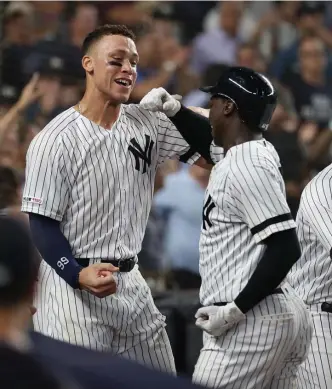  ?? GETTY IMAGES ?? DEEP IMPACT: Didi Gregorius (right) celebrates his grand slam with Aaron Judge, who also homered in the eighth inning to rally the Yankees past the Rays, 8-3.