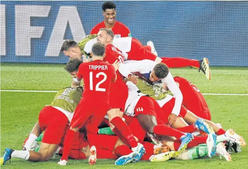  ??  ?? England players celebrate after winning the penalty shoot-out against Colombia.