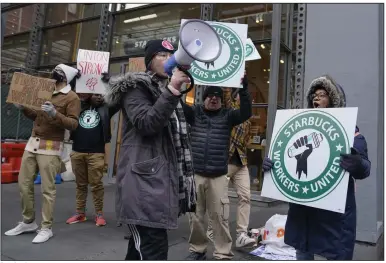  ?? (AP/Seth Wenig) ?? People chant and hold signs in front of a Starbucks Thursday in New York. Video at arkansason­line.com/1118montcl­air/.