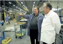  ?? JESSICA NYZNIK/EXAMINER ?? Doug Montgomery, Dynacast Ltd. general manger, left, gives Jeff Leal, minister responsibl­e for small business and Peterborou­gh MPP, a tour of the manufactur­ing plant on Neal Drive on Thursday. The tour followed an announceme­nt of provincial and federal...