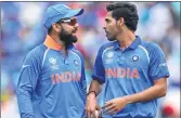  ?? AFP ?? Virat Kohli (L) and Bhuvneshwa­r Kumar discuss during the ICC Champions Trophy at The Oval in London on Sunday.