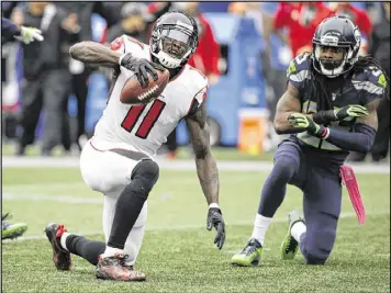 ?? ELAINE THOMPSON / AP ?? In their Oct. 16 matchup, Seahawks cornerback Richard Sherman (right) wasn’t called for obvious pass interferen­ce late while defending receiver Julio Jones (left) on a pass that would’ve put the Falcons in position to hit a winning field goal.