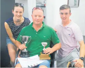  ?? ?? Stephanie, Terry and Cameron Walker with the judges’ and popular vote trophies for best home at the prizegivin­g.