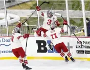 ?? CLEVELAND.COM VIA AP ?? Ohio State’s Joe Dunlap (left) and Patrick Guzzo (71) celebrate after a goal by teammate Cole McWard (3) Feb. 18. After three seasons without a tournament run, the Buckeyes are hungry for a return.